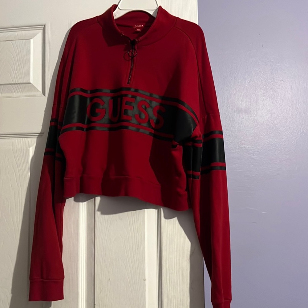 this is a guess red and black shirt that has a small turtle neck at the top